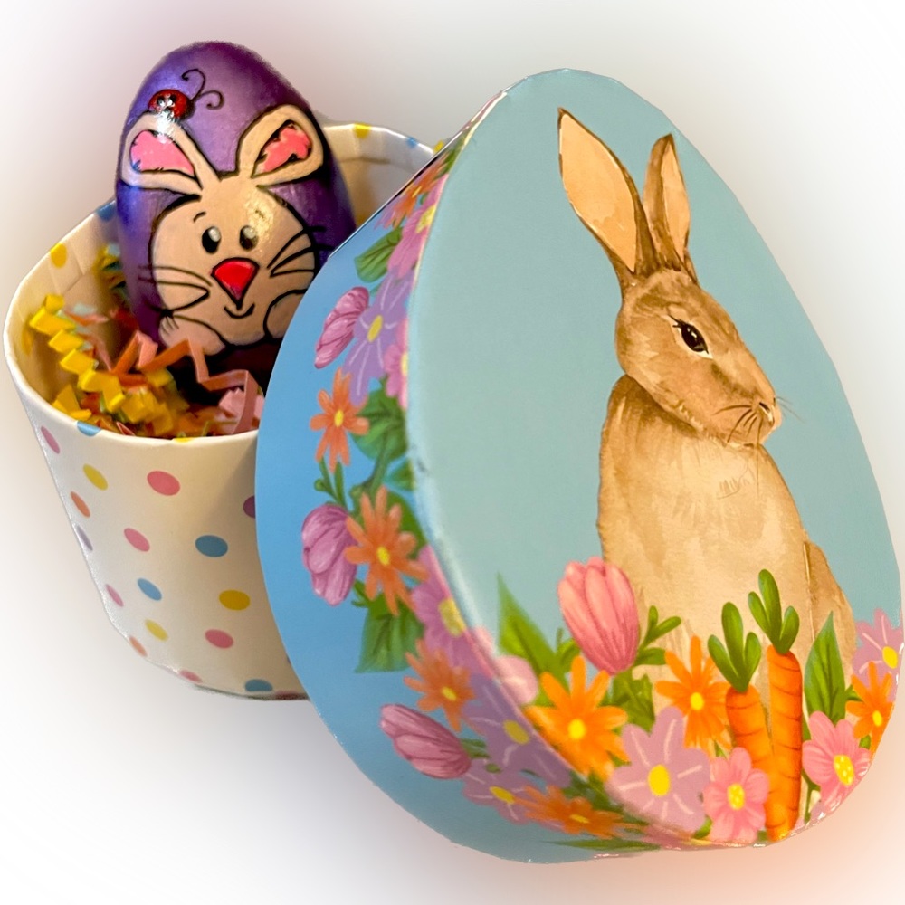 Hand crafted painted rock Easter bunny egg in decorative cardboard container